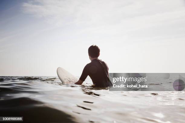 male surfer waiting for waves - surfing wave stock pictures, royalty-free photos & images