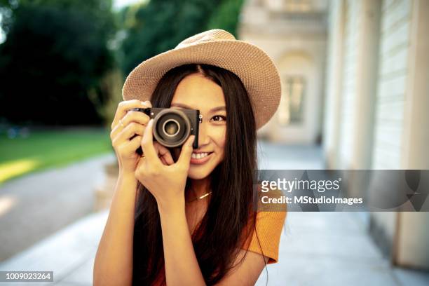 portrait of chinese woman making a photo. - pioneer photographer of motion stock pictures, royalty-free photos & images