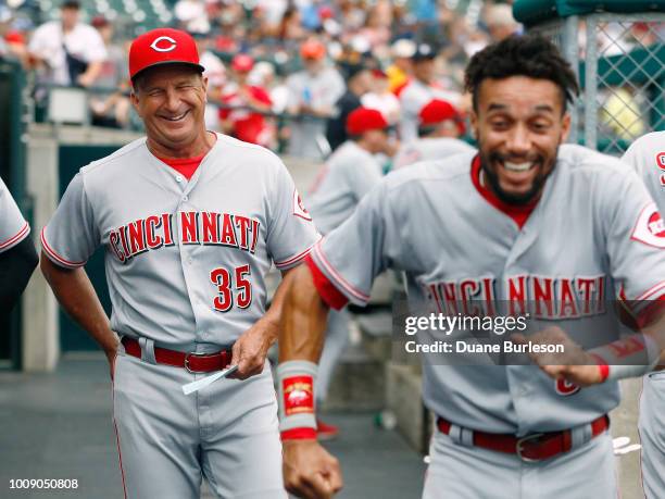 Interim manager Jim Riggleman of the Cincinnati Reds laughs at the antics of Billy Hamilton of the Cincinnati Reds before a game against the Detroit...