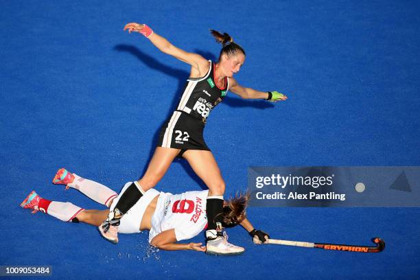 Maria Lopez of Spain and Cecile Pieper of Germany clash during the quarter final game between Germany and Spain of the FIH Womens Hockey World Cup at...