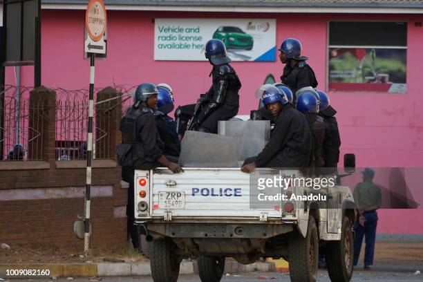 An Zimbabwian police are seen as supporters of the opposition party protest against the results of Zimbabwes presidential election, in Harare on 01...