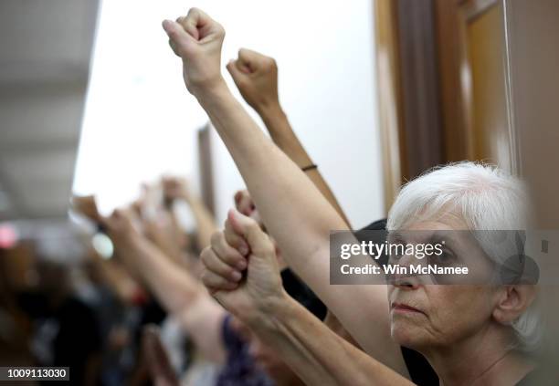 Protesters opposed to the nomination of Supreme Court nominee Judge Brett Kavanaugh gather outside the office of Sen. John Thune prior to a scheduled...