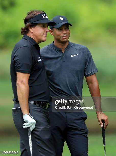 Phil Mickelson and Tiger Woods pose for a picture during a preview day of the World Golf Championships - Bridgestone Invitational at Firestone...