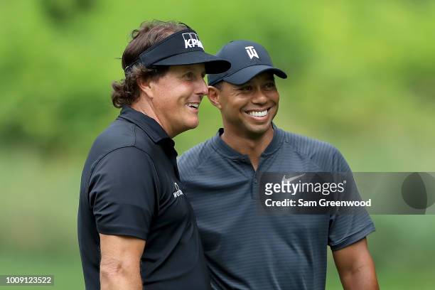 Phil Mickelson and Tiger Woods smile during a practice round prior to the World Golf Championships-Bridgestone Invitational at Firestone Country Club...