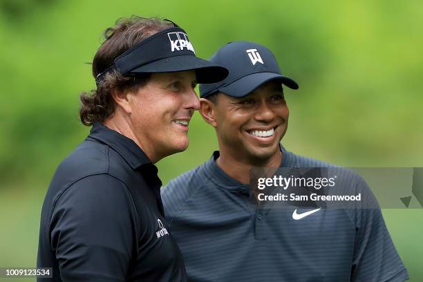 Phil Mickelson and Tiger Woods smile during a practice round prior to the World Golf Championships-Bridgestone Invitational at Firestone Country Club...