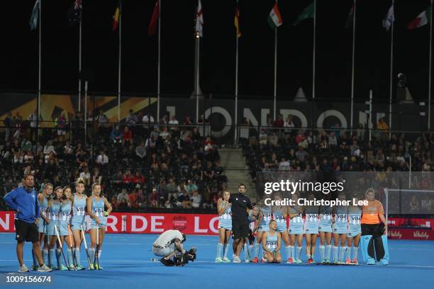 Argentina players stand together as they wait for Australia to take their penalty shoot out during the Quarter Final game between Australia and...