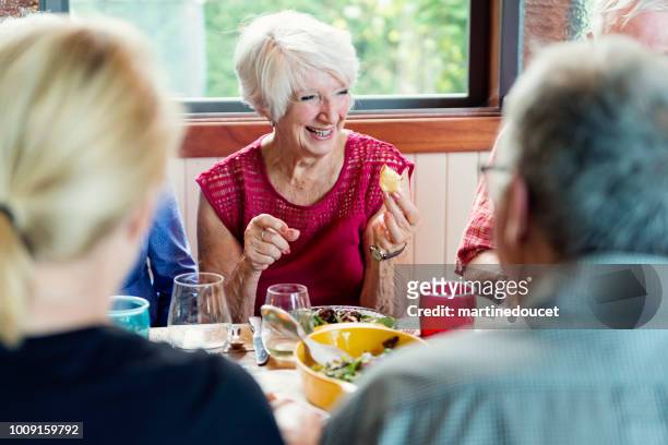 group of seniors having dinner in summer house. - lunch cheese imagens e fotografias de stock