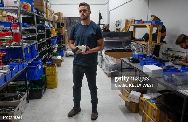 Cody Wilson, owner of Defense Distributed company, holds a 3D printed gun, called the "Liberator", in his factory in Austin, Texas on August 1, 2018....