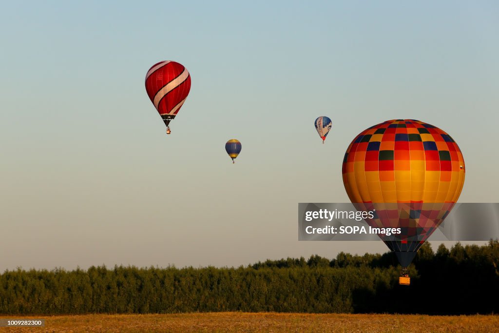 Balloons are seen flying.
The Aeronautics championship takes...