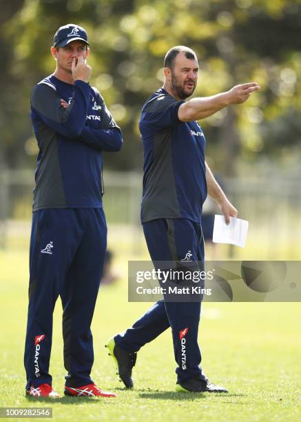 Wallabies coach Michael Cheika and attack coach Stephen Larkham talk to players during a Wallabies training session at Moore Park on August 2, 2018...