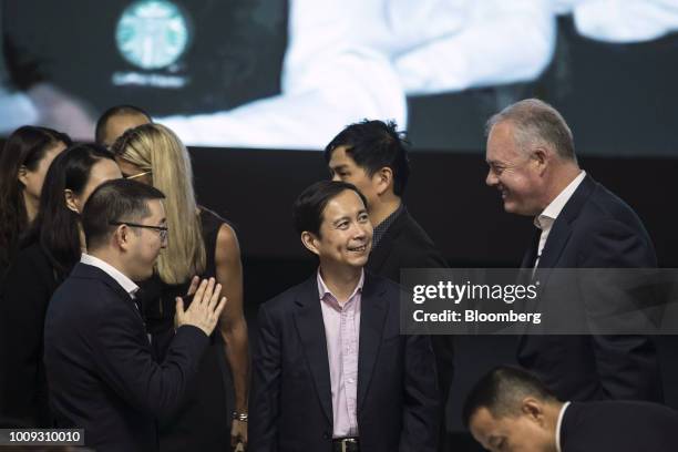 Kevin Johnson, chief executive officer of Starbucks Corp., right, speaks with Daniel Zhang, chief executive officer of Alibaba Group Holding Ltd.,...