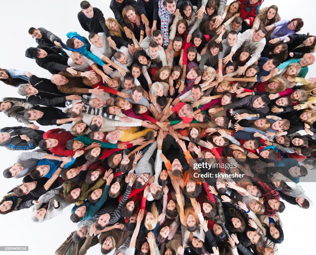 Above view of happy group of people joining hands in unity.