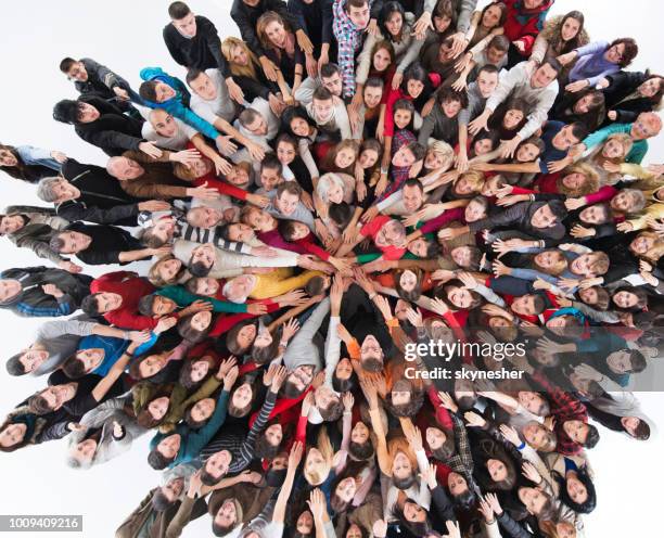 above view of happy group of people joining hands in unity. - sea of hands stock pictures, royalty-free photos & images