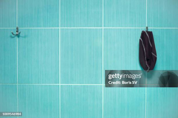 swimming cap in public swimming pool - pool tiles stock pictures, royalty-free photos & images