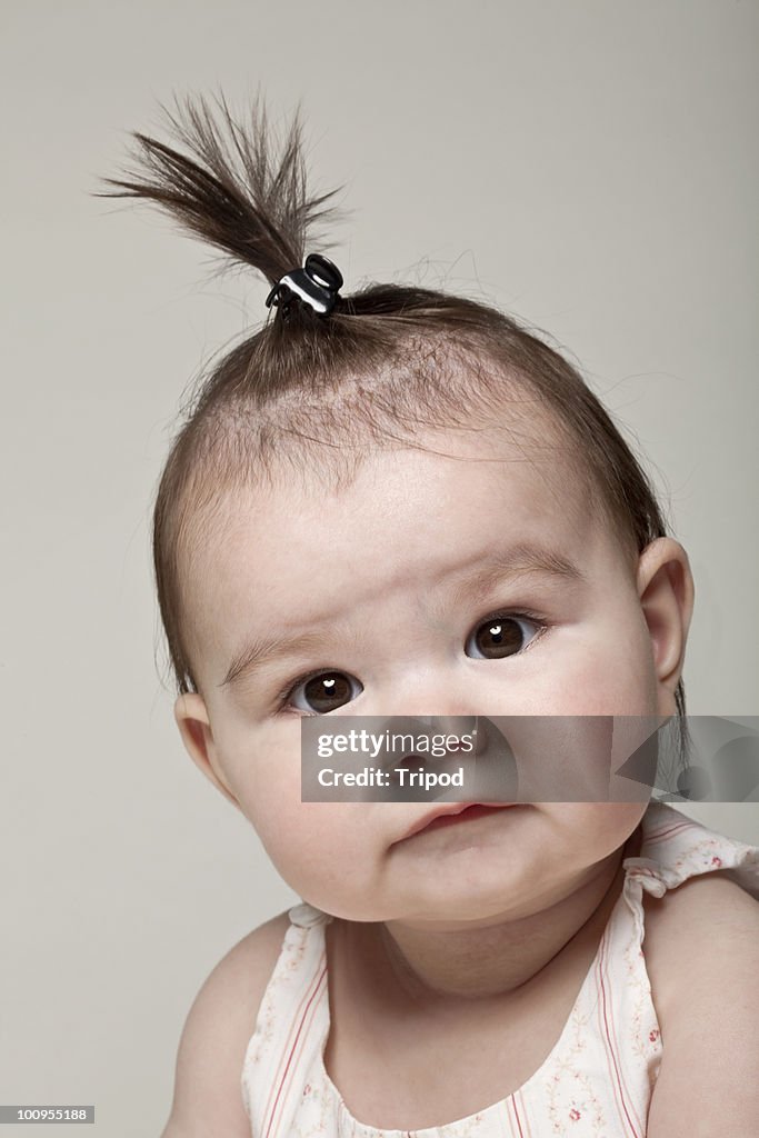 Baby girl (6-9 months) with hair in clip