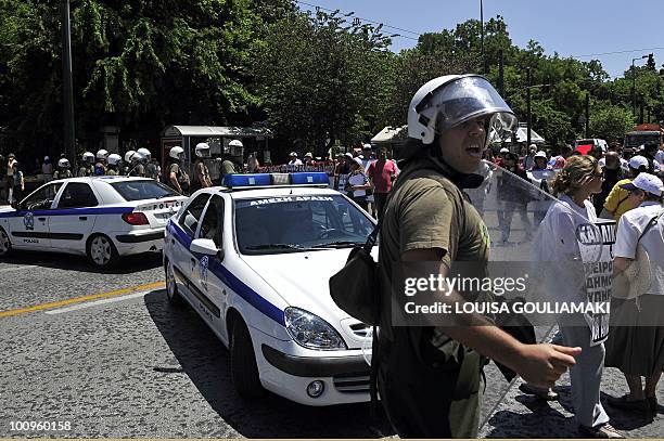 Greek riot police block the way to the parliament in the center of the Greek capital on May 26, 2010 as Athens municipal workers protest against a...