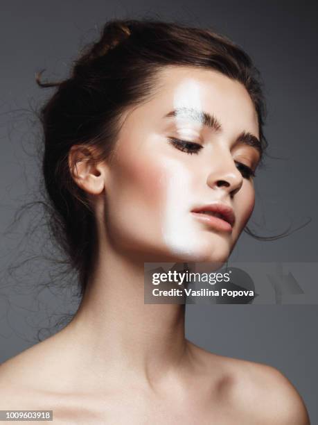 beautiful young woman with white strip make-up - beauty treatment face stock-fotos und bilder