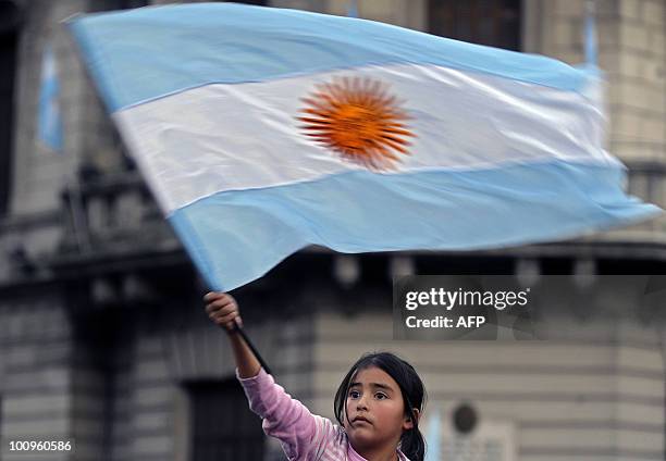 Girl waves Argentina's national flag on May 25, 2010 during the celebrations for the Bicentenary of the May Revolution that led to the country's...