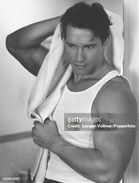 Actor Arnold Schwarzenegger towels himself off on the set of the film 'Raw Deal', 1986.