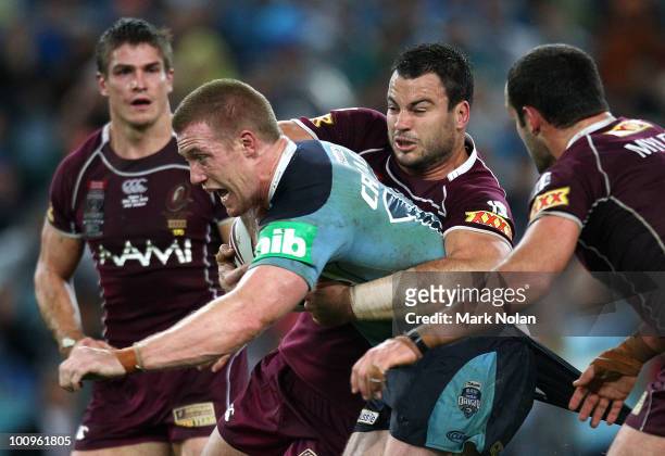 Ben Creagh of the Blues is tackled during game one of the ARL State of Origin series between the New South Wales Blues and the Queensland Maroons at...