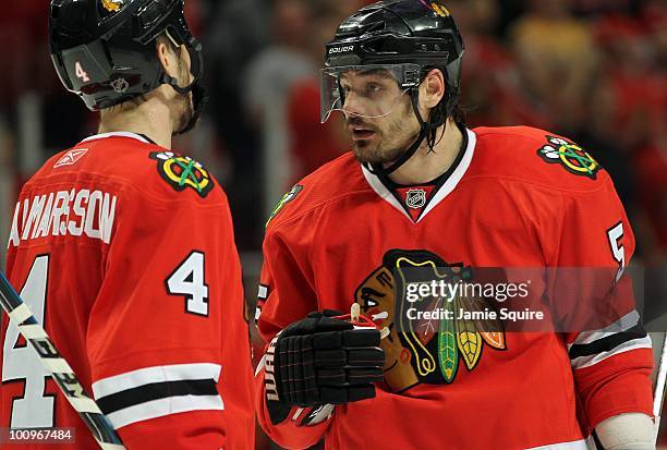 Brent Sopel of the Chicago Blackhawks talks with teammate Niklas Hjalmarsson while taking on the San Jose Sharks in Game Four of the Western...