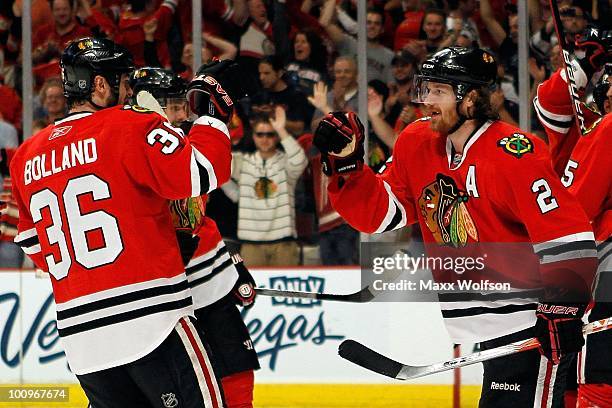 Dave Bolland and Duncan Keith of the Chicago Blackhawks celebrate as the Blackhawks defeat the San Jose Sharks 4-2 to advance to the Stanley Cup...