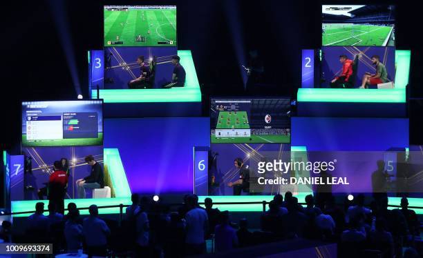 Players compete on Microsoft Xbox and Sony Playstation games consoles in the group stages of the FIFA eWorld Cup Grand Final, at the O2 in London on...