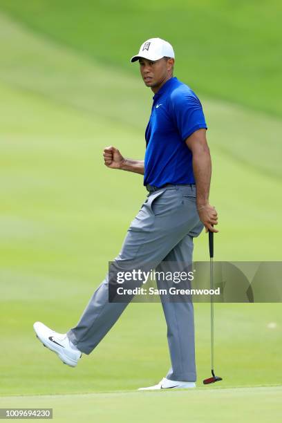 Tiger Woods reacts after making birdie on the 18th green during World Golf Championships-Bridgestone Invitational - Round One at Firestone Country...