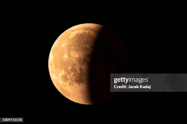 moon partial eclipse - eclipse fotografías e imágenes de stock