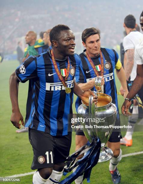 Sulley Muntari and captain Javier Zanetti of Inter Milan celebrate with the trophy after winning the UEFA Champions League Final match between Bayern...