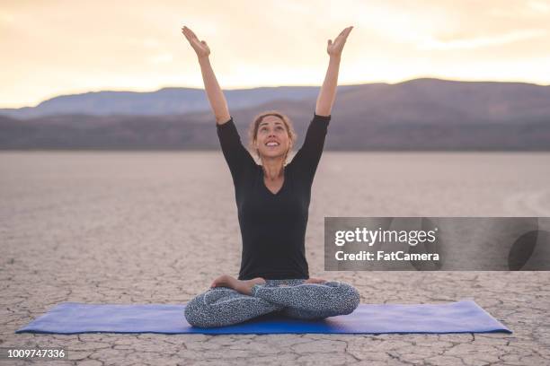 ethnic woman doing yoga in the desert - stir crazy stock pictures, royalty-free photos & images