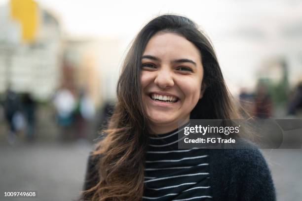 young woman portrait in the city - white woman headshot stock pictures, royalty-free photos & images