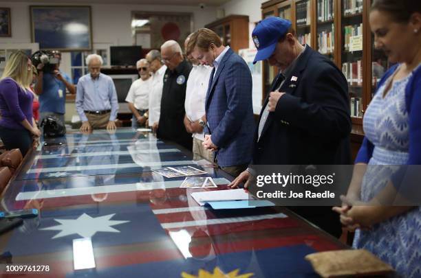 Adam Putnam participates in a moment of silence for those lost in the war, as he attends a campaign event at the Bay of Pigs Veterans Association...