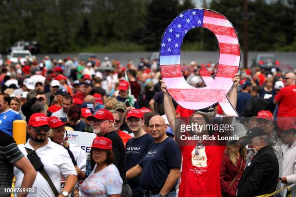 David Reinert holds up a large "Q" sign while waiting in line to see President Donald J. Trump at his rally on August 2, 2018 at the Mohegan Sun...
