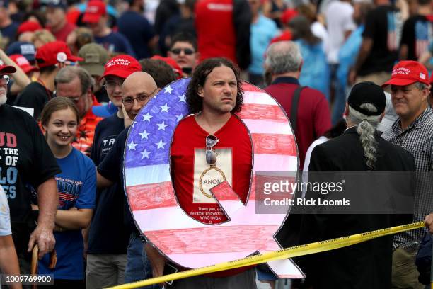 David Reinert holds a large "Q" sign while waiting in line on to see President Donald J. Trump at his rally August 2, 2018 at the Mohegan Sun Arena...