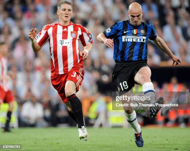 Bastian Schweinsteiger of Bayern Munich with Esteban Cambiasso of Inter Milan during the UEFA Champions League Final match between Bayern Munich and...