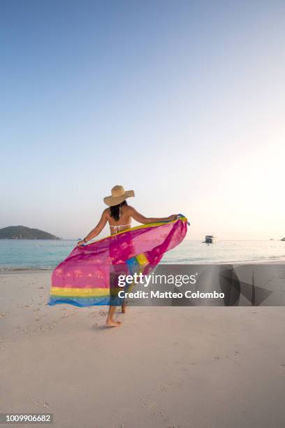 woman with sarong on tropical beach, thailand - sarong stock-fotos und bilder