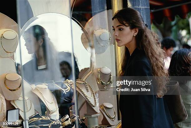 latin woman looks at jewelry in caracas, venezuela - jewellery shopping stock pictures, royalty-free photos & images