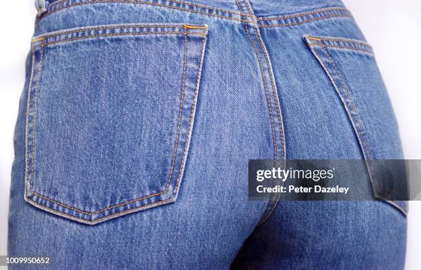 close up of the bottom of a woman wearing denim jeans - rear end foto e immagini stock