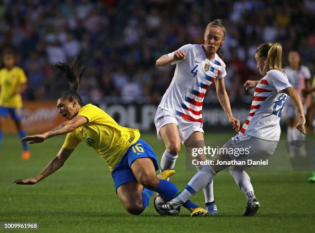Becky Sauerbrunn and Emily Sonnett of the United States take down Beatriz of Brazil during the 2018 Tournament Of Nations at Toyota Park on August 2,...