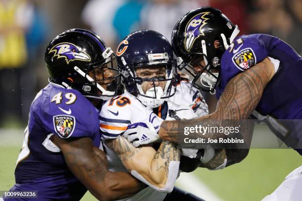 Kamalei Correa and Chris Board of the Baltimore Ravens are called for an illegal hit while tackling Tanner Gentry of the Chicago Bears in the third...