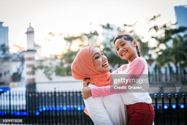 back to school - mother preparing daughter for school and sharing love - malaysian culture stock pictures, royalty-free photos & images