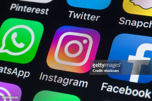 whatsapp, instagram, facebook and other phone apps on iphone screen - social media stock pictures, royalty-free photos & images