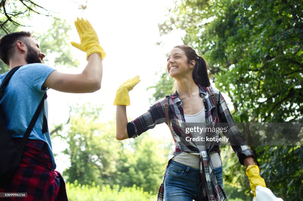 Young volunteers collect garbage in a public park