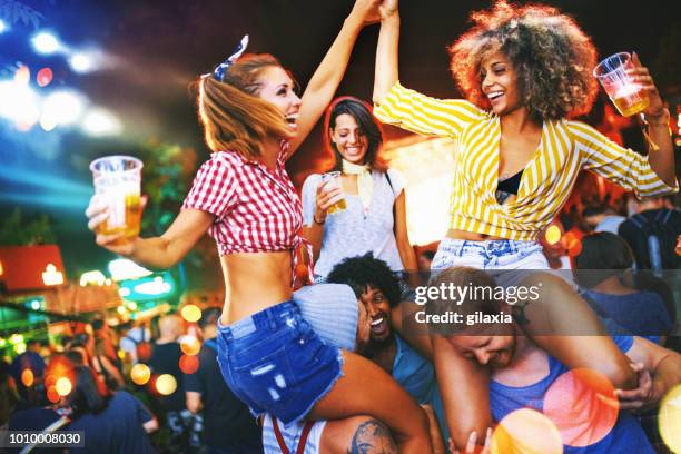 friends dancing at a concert. - on shoulders at concert stock pictures, royalty-free photos & images