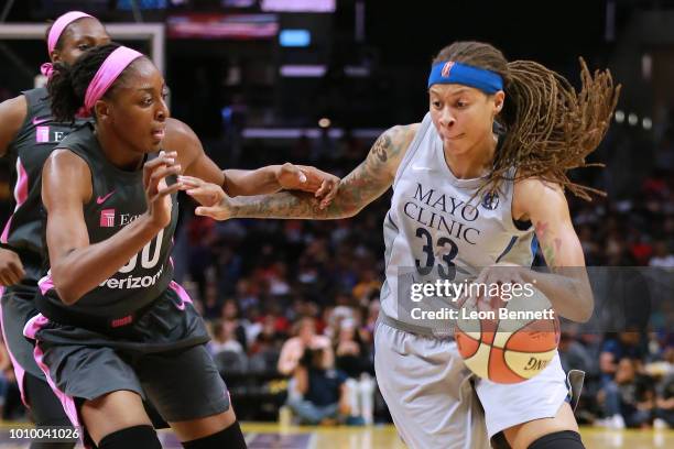 Seimone Augustus of the Minnesota Lynx handles the ball against Nneka Ogwumike of the Los Angeles Sparks during a WNBA basketball game at Staples...