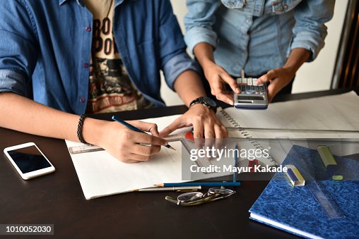 University Students studying Engineering drawing University Students studying Engineering drawing