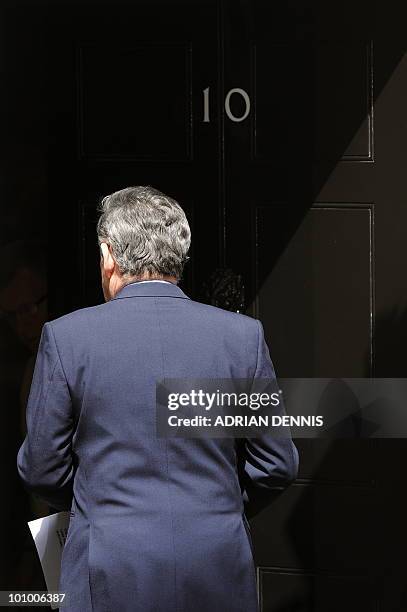 Britain's Prime Minister and Leader of the Labour Party Gordon Brown walks back into 10 Downing Street after addressing the media in London, on May...