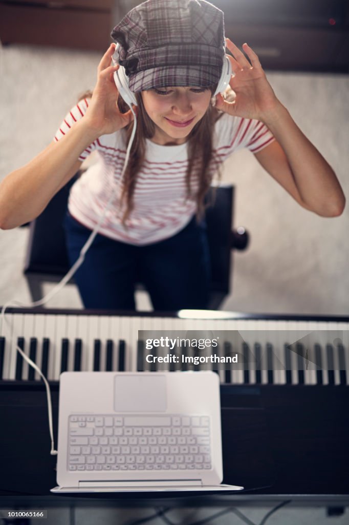 Teenager girl composing on digital piano