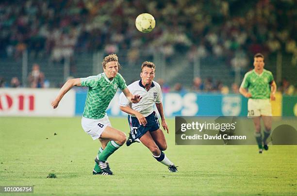 Guido Buchwald of the Federal Republic of Germany challenges David Platt of England during the FIFA World Cup Finals 1990 Semi-Final match between...